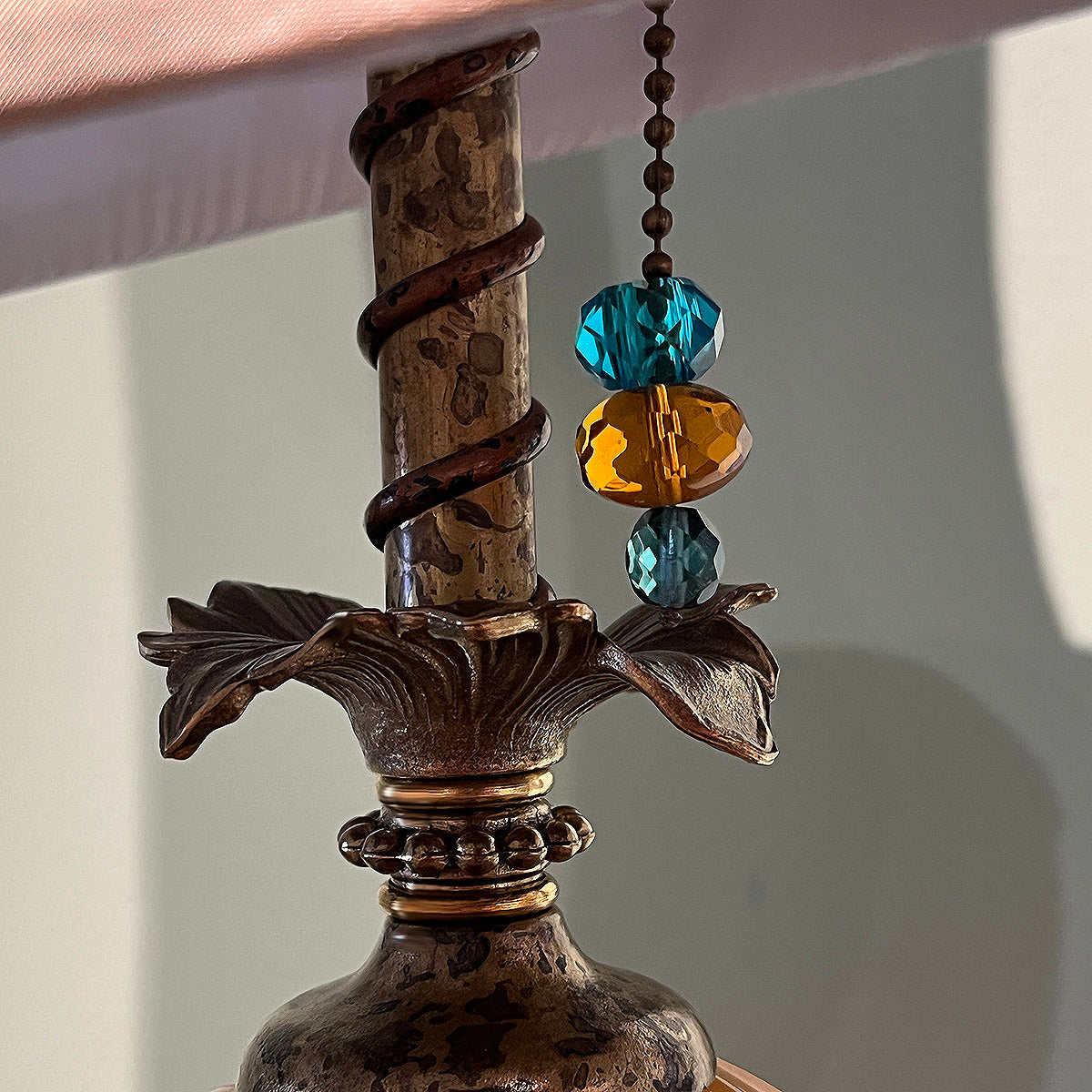 opaque blown glass and coiled copper around the neck of the lamp.